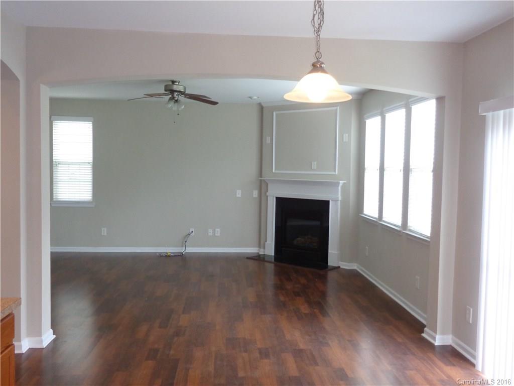 6517 Del Rio Road Charlotte, NC 28277 - Photo 6 of 15 a view of an empty room with wooden floor and a window