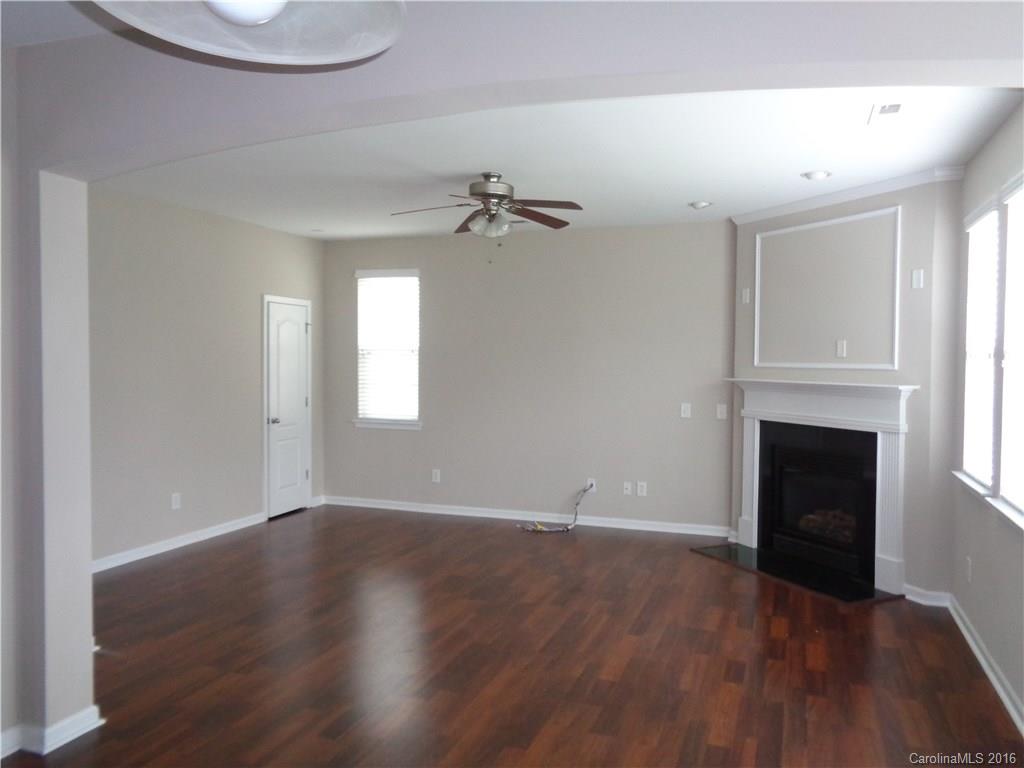6517 Del Rio Road Charlotte, NC 28277 - Photo 7 of 15 a view of an empty room with a fireplace and a window