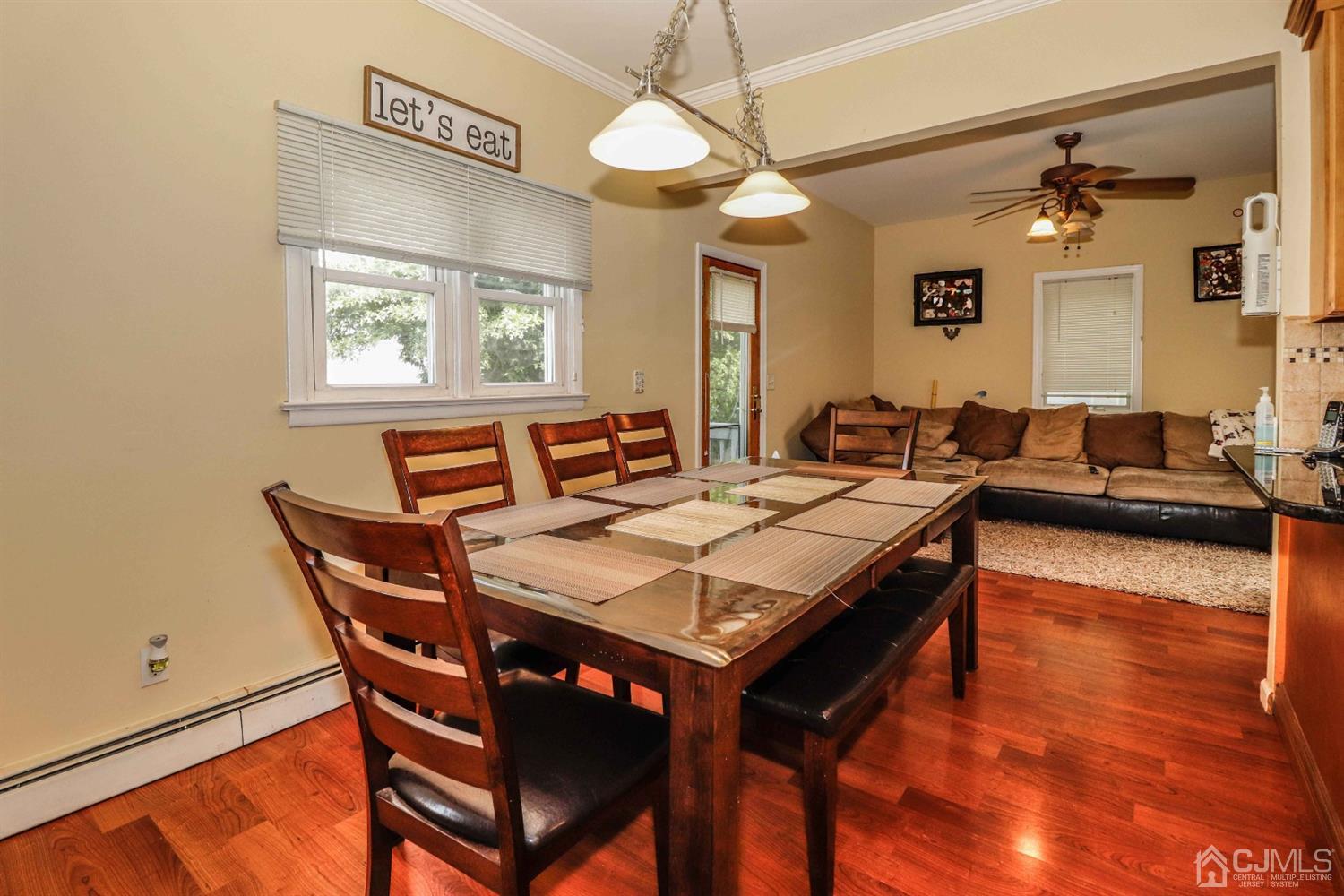 166 Brower Avenue Edison, NJ 08837 - Photo 12 of 48 a dining room with a wooden table and chairs