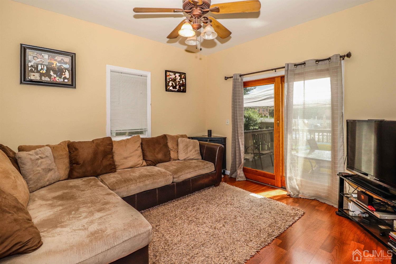 166 Brower Avenue Edison, NJ 08837 - Photo 13 of 48 a living room with furniture and a flat screen tv