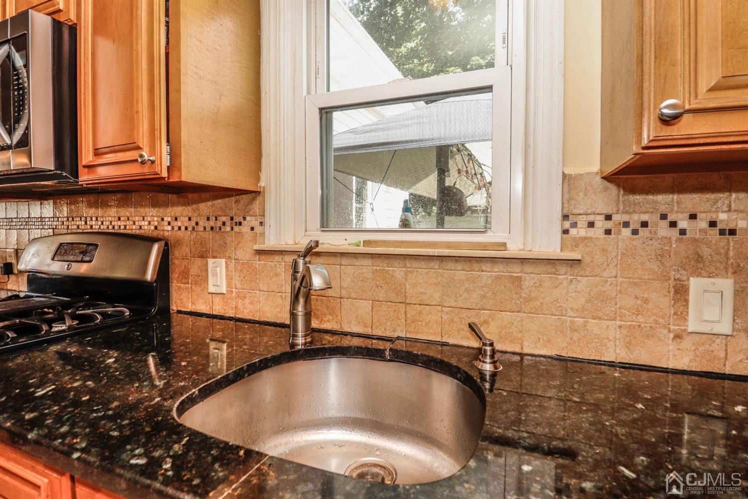 166 Brower Avenue Edison, NJ 08837 - Photo 18 of 48 a kitchen with a sink and a window