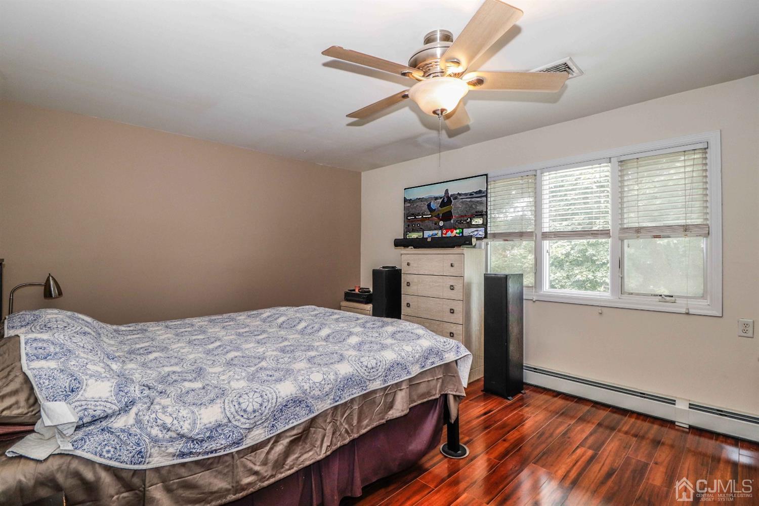 166 Brower Avenue Edison, NJ 08837 - Photo 23 of 48 a bedroom with a bed and a chandelier