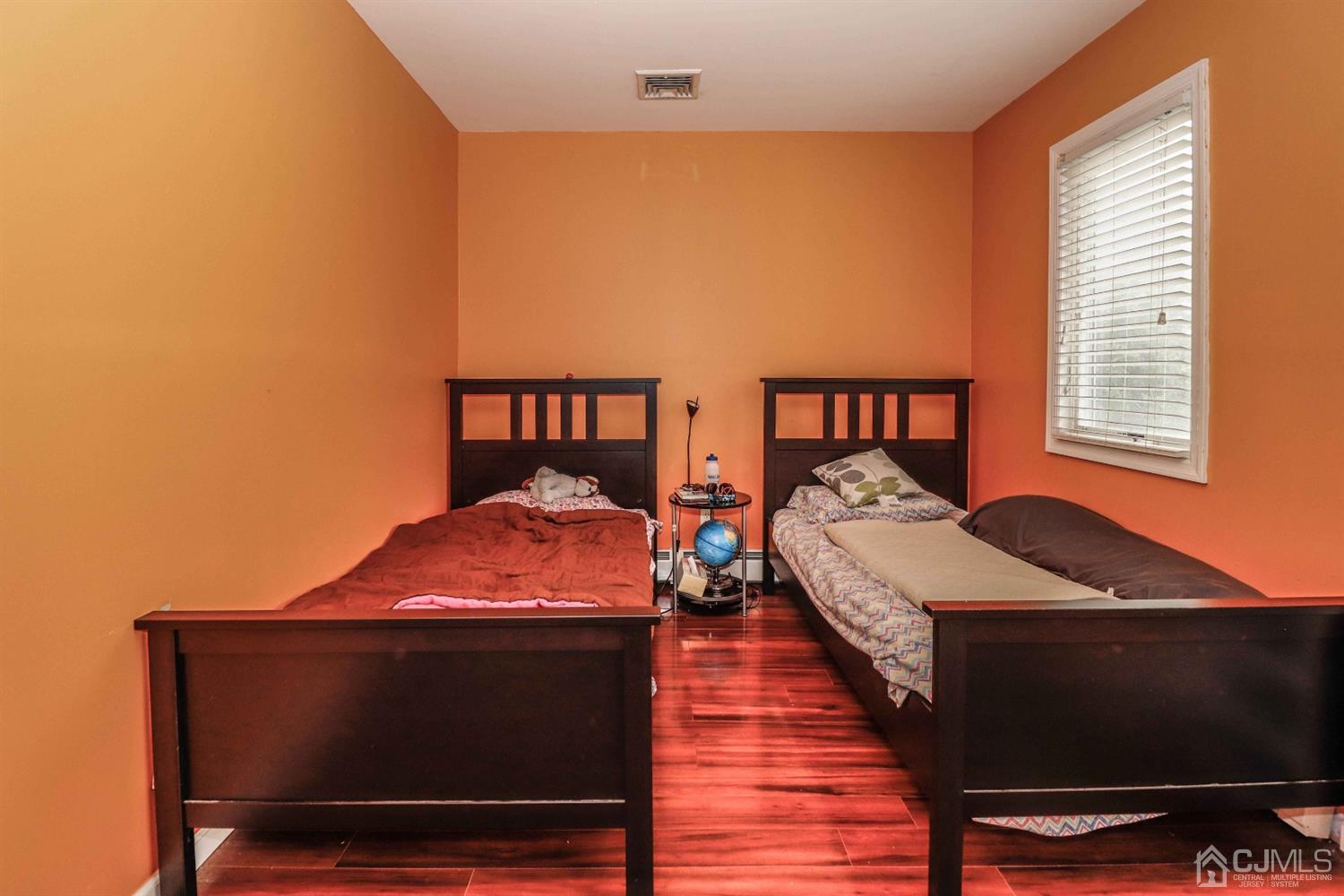166 Brower Avenue Edison, NJ 08837 - Photo 27 of 48 a bed sitting in a bedroom next to a window