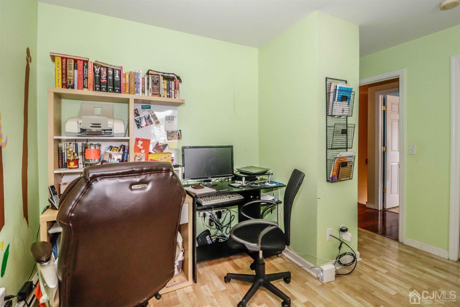 166 Brower Avenue Edison, NJ 08837 - Photo 33 of 48 a view of a workspace with furniture and a bookshelf