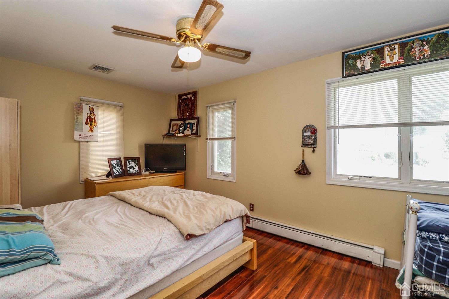 166 Brower Avenue Edison, NJ 08837 - Photo 35 of 48 a bedroom with a bed chandelier and a window