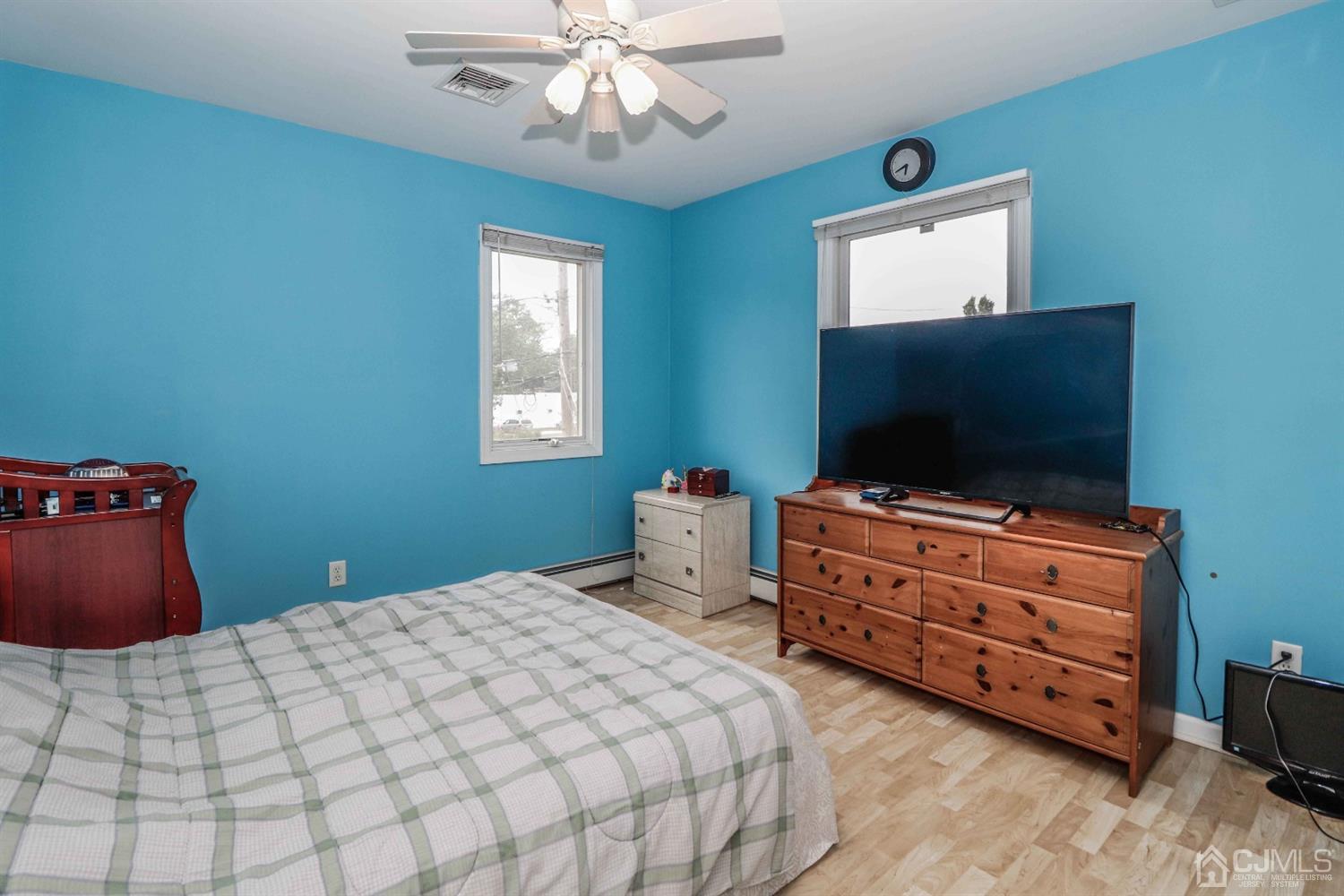 166 Brower Avenue Edison, NJ 08837 - Photo 37 of 48 a bedroom with a bed and a flat screen tv