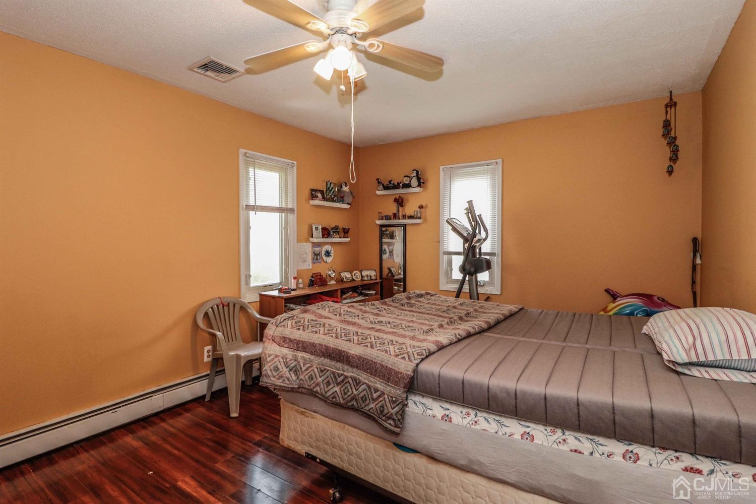 166 Brower Avenue Edison, NJ 08837 - Photo 38 of 48 a bedroom with a bed and a chandelier
