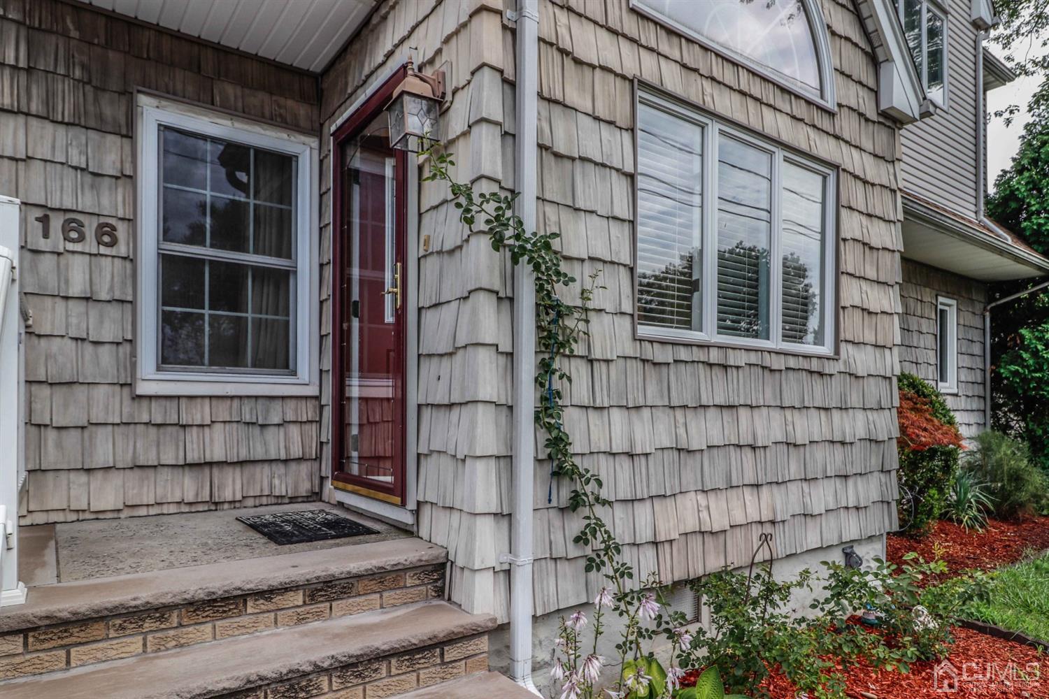 166 Brower Avenue Edison, NJ 08837 - Photo 43 of 48 a view of a house with a window and flower plants