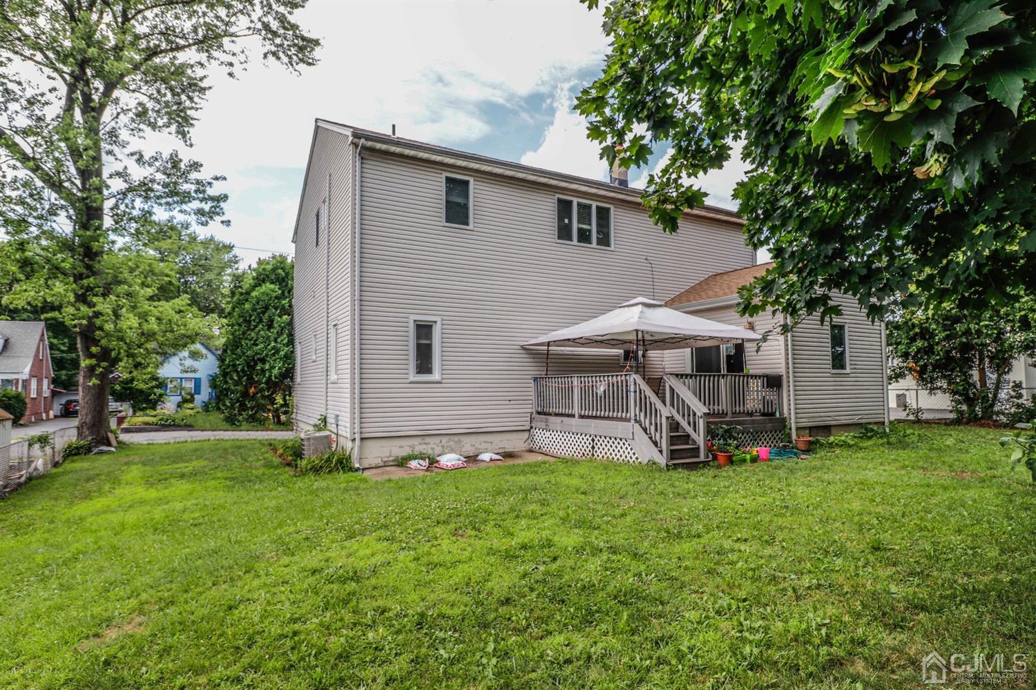 166 Brower Avenue Edison, NJ 08837 - Photo 45 of 48 a front view of house with a garden and trees