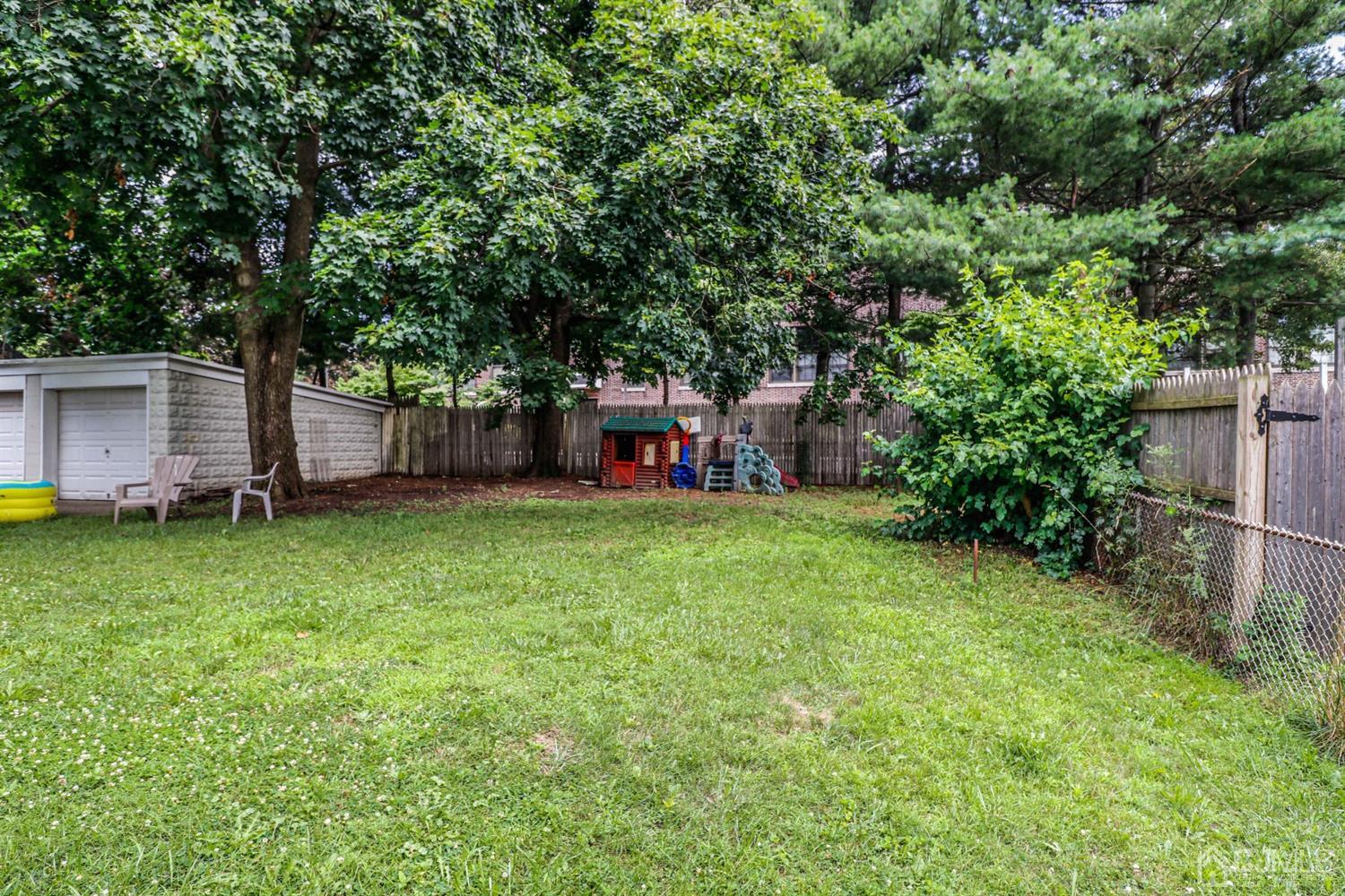166 Brower Avenue Edison, NJ 08837 - Photo 46 of 48 a view of a backyard with a garden and entertaining space