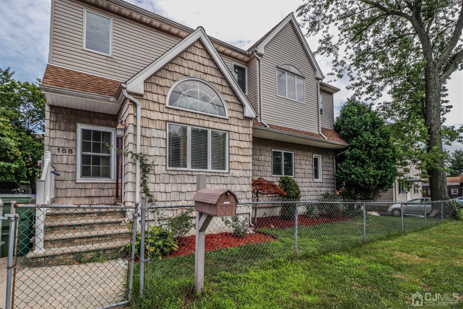 166 Brower Avenue Edison, NJ 08837 - Photo 48 of 48 a front view of a house with a yard table and chairs