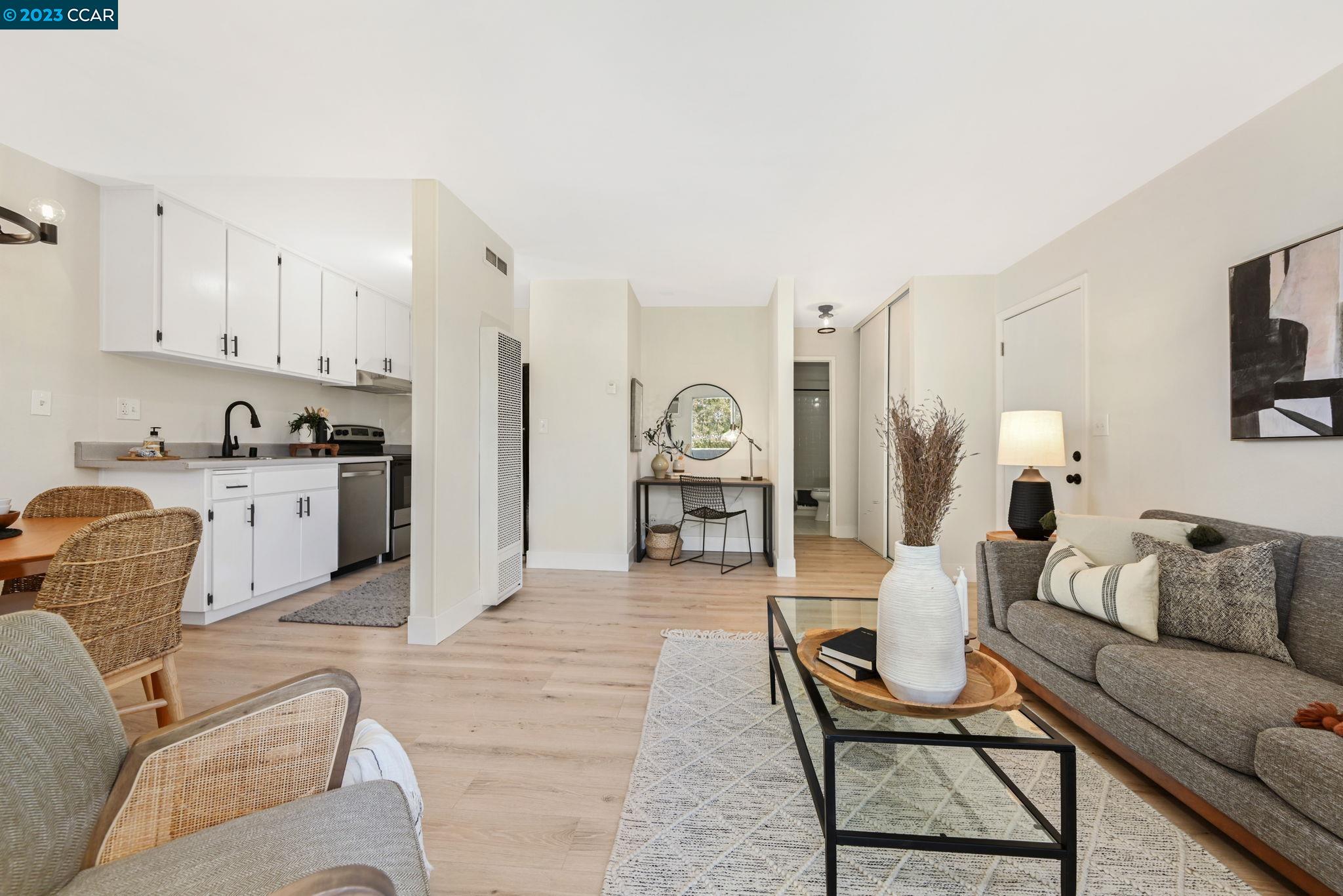 971 Bancroft Road, Unit 205 Concord, CA 94518 - Photo 1 of 1 a living room with furniture and a dining table with kitchen view