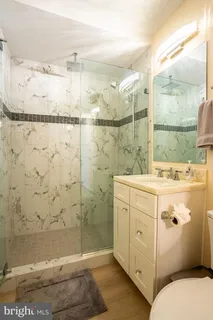 a bathroom with a shower sink and mirror