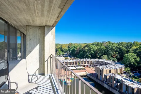 a view of a balcony with wooden floor and fence