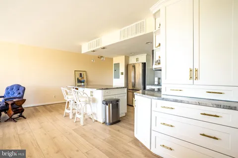 a kitchen with a sink cabinets and dining table