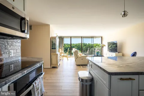 a kitchen with a sink and wooden floor