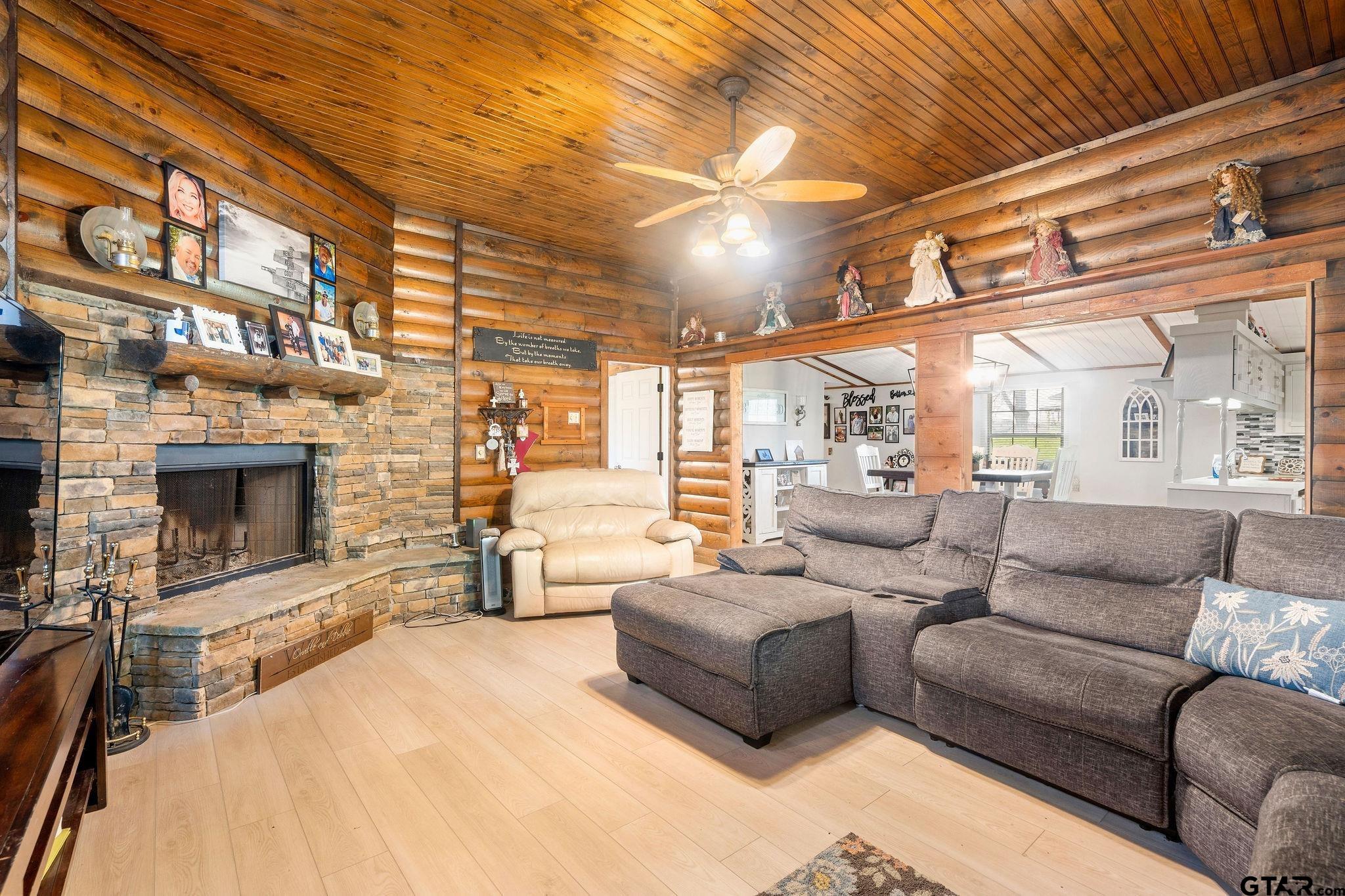 4550 Crabapple Road Gilmer, TX 75645 - Photo 23 of 33 a living room with furniture and a fireplace