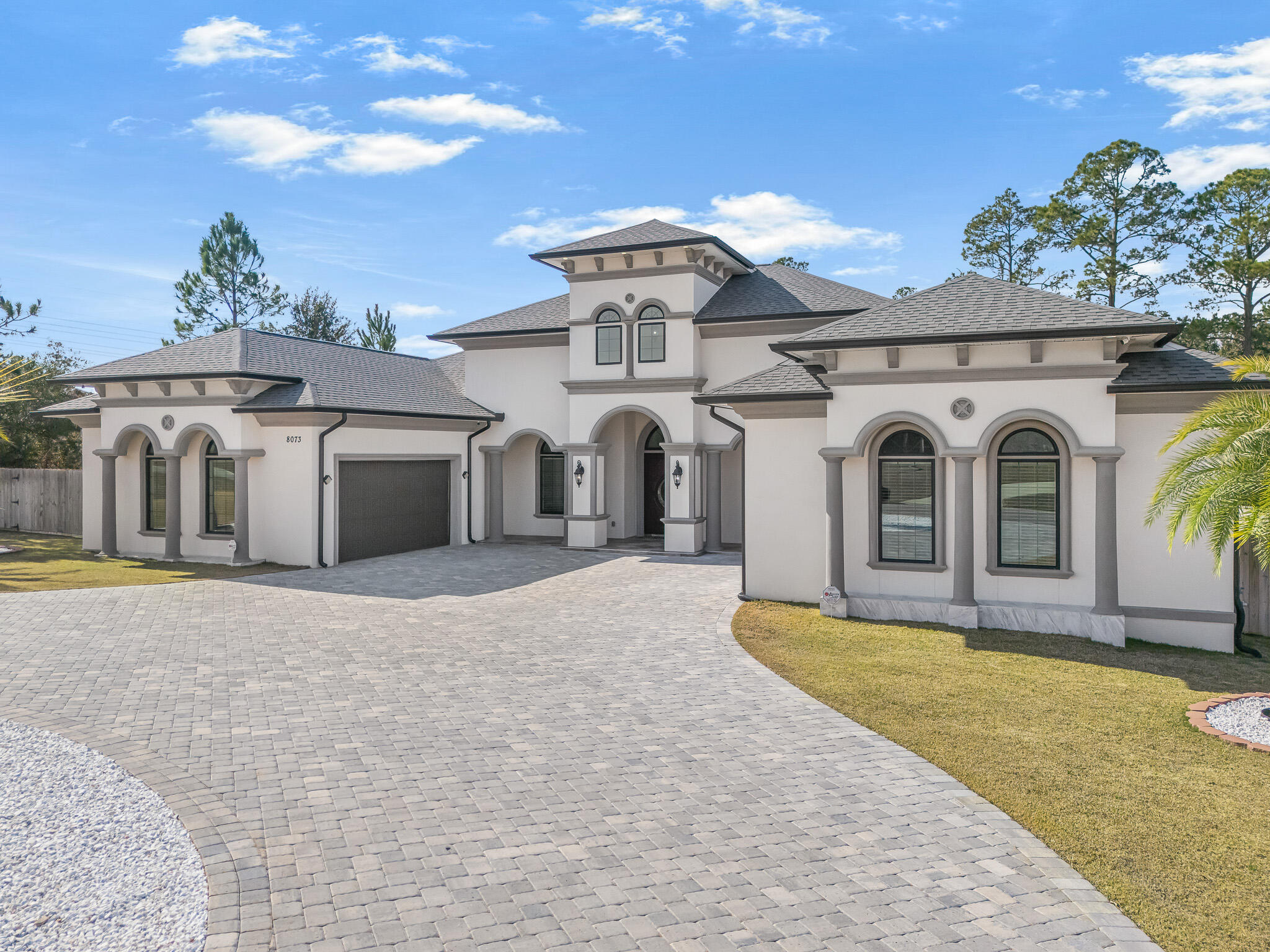 8073 Thoroughbred Road Pensacola, FL 32526 - Photo 2 of 65 a view of a white house with a yard and potted plants
