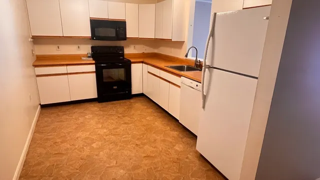 a kitchen with stainless steel appliances a refrigerator a stove a microwave and cabinets