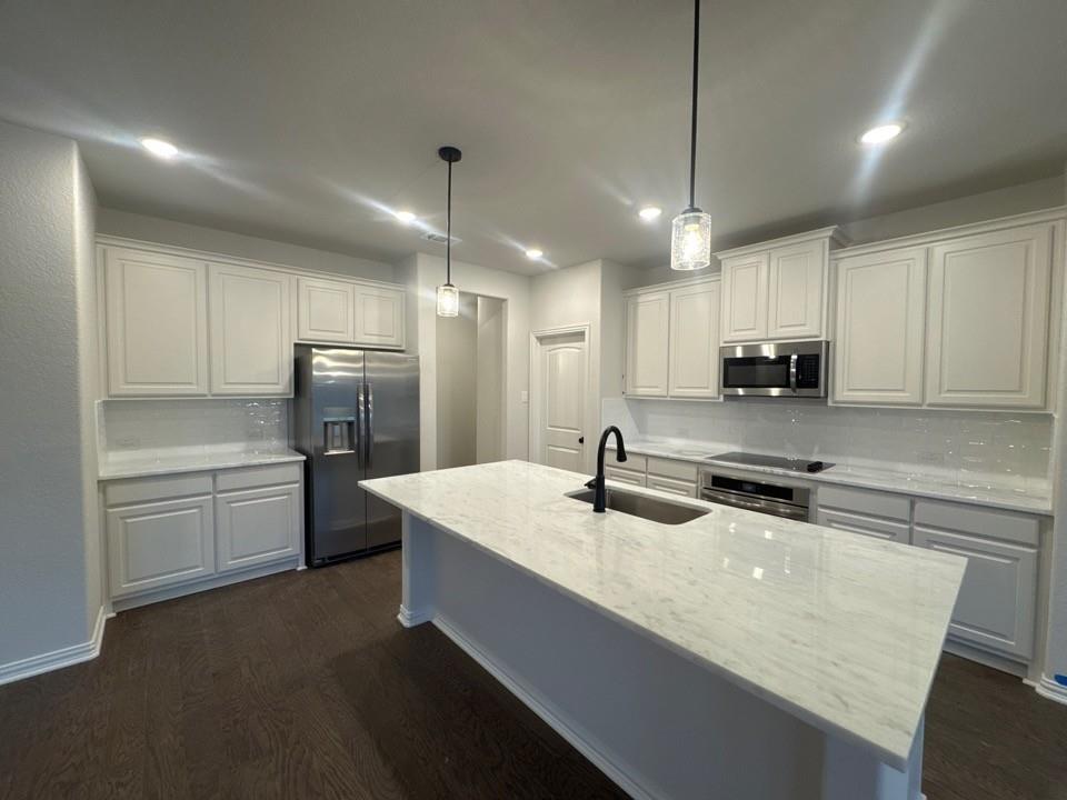 9013 County Road 623 Blue Ridge, TX 75424 - Photo 7 of 15 a kitchen with stainless steel appliances granite countertop a sink a stove a refrigerator a center island and cabinets