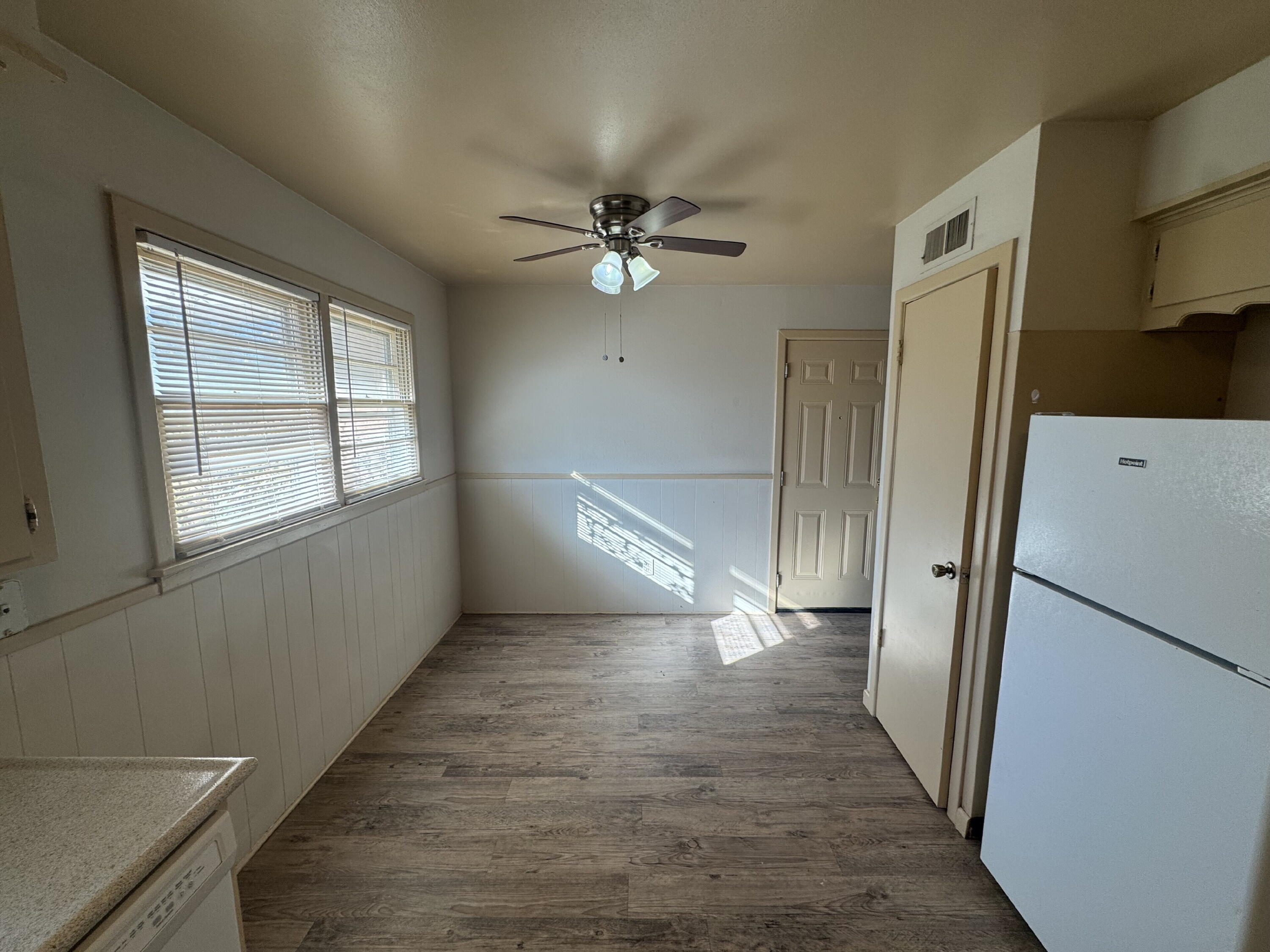 5230 14th Street Lubbock, TX 79416 - Photo 4 of 9 wooden floor in an empty room with a window