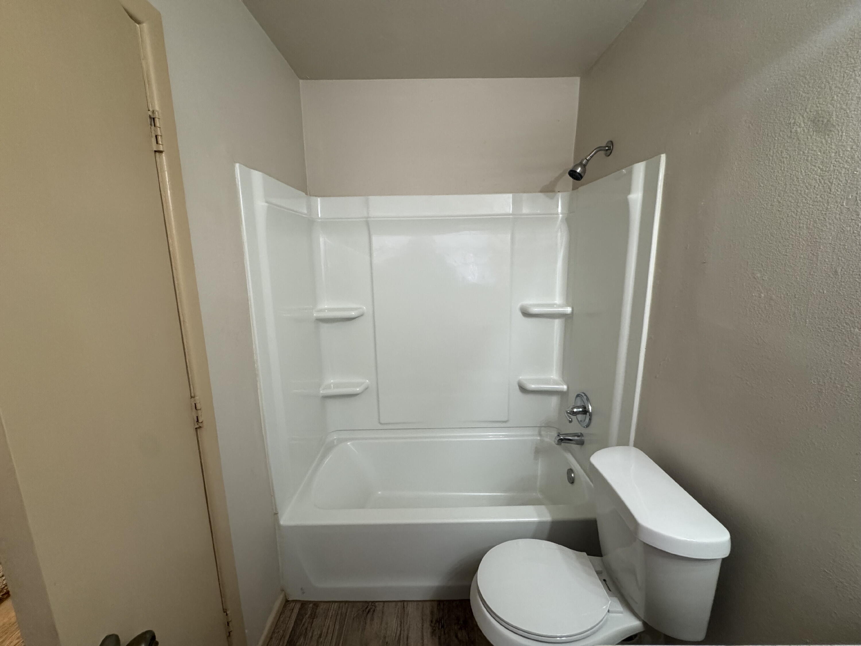 5230 14th Street Lubbock, TX 79416 - Photo 7 of 9 a bathroom with a toilet and a bath tub