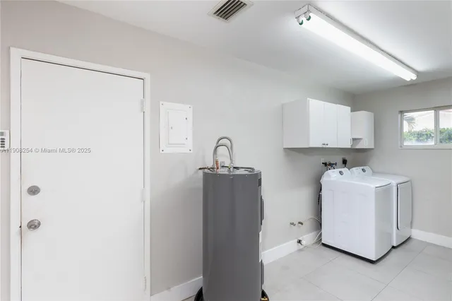 a room with a refrigerator and a sink