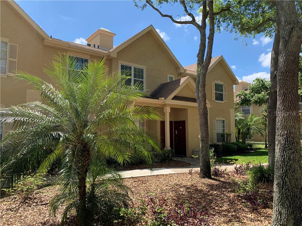 875 Grand Regency Pointe, Unit 204 Altamonte Springs, FL 32714 - Photo 1 of 1 a view of a white house next to a yard with a tree