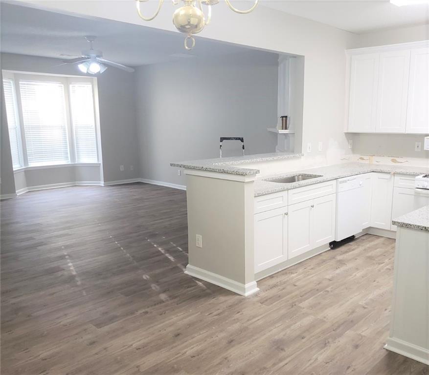 4081 Howell Park Road Duluth, GA 30096 - Photo 2 of 12 a kitchen with a sink cabinets and wooden floor