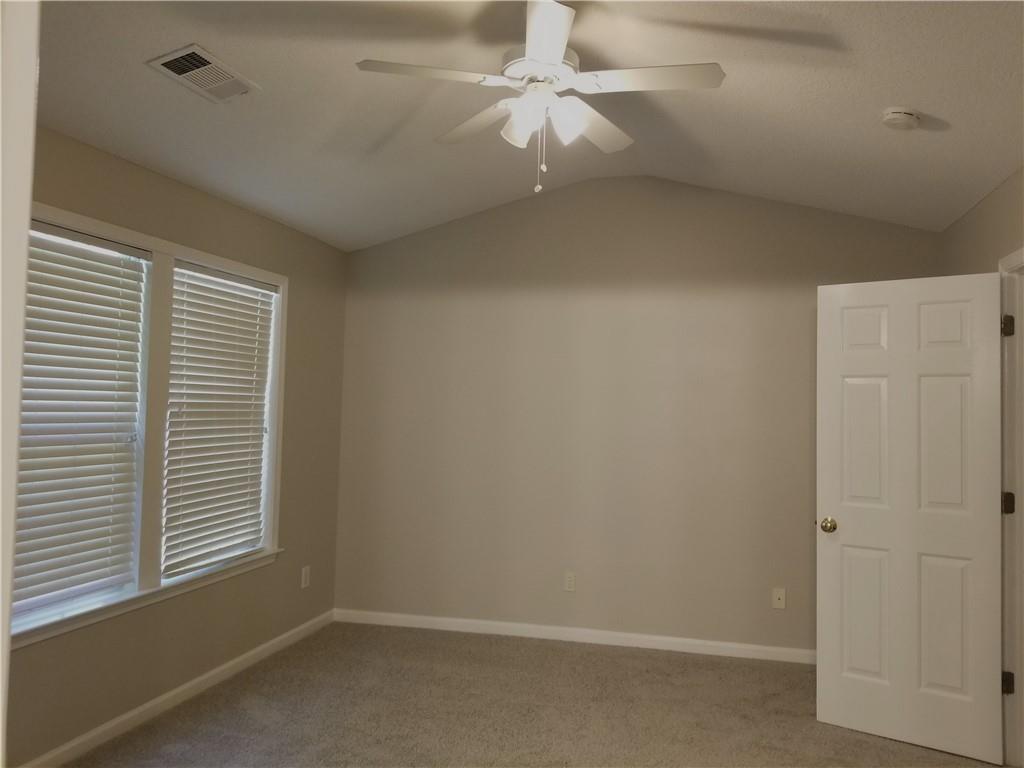 4081 Howell Park Road Duluth, GA 30096 - Photo 9 of 12 an empty room with a window and a fan