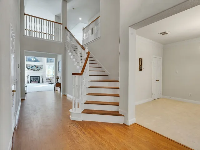 a view of a hallway with wooden floor and entryway