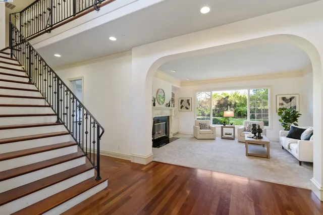 a view of a livingroom with furniture hardwood floor and staircase