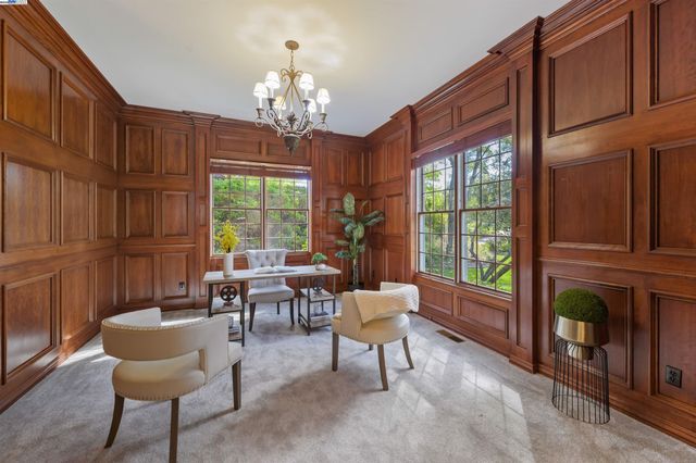 a dining room with furniture a livingroom view and wooden floor