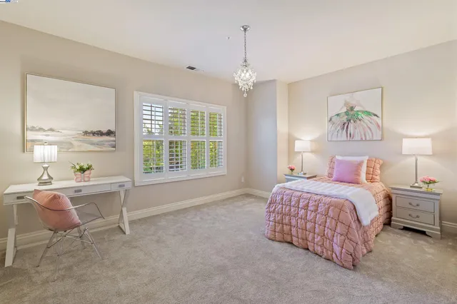 a spacious bedroom with a bed and a window