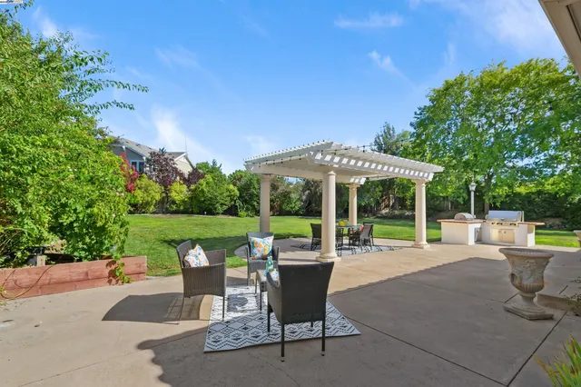 a patio with yard table and chairs