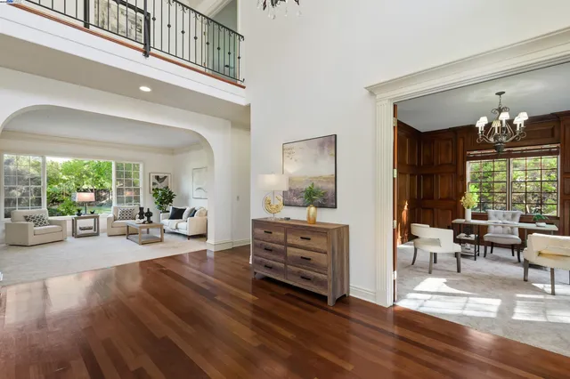 a living room with furniture and large windows