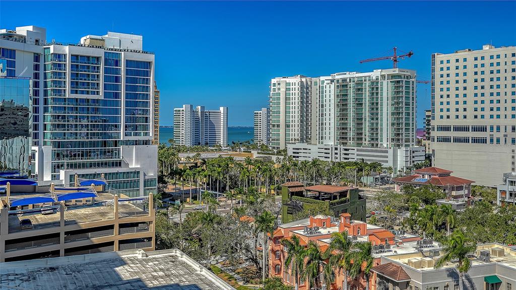 1255 North Gulfstream Avenue, Unit 1101 Sarasota, FL 34236 - Photo 12 of 75 a patio with table and chairs and potted plants