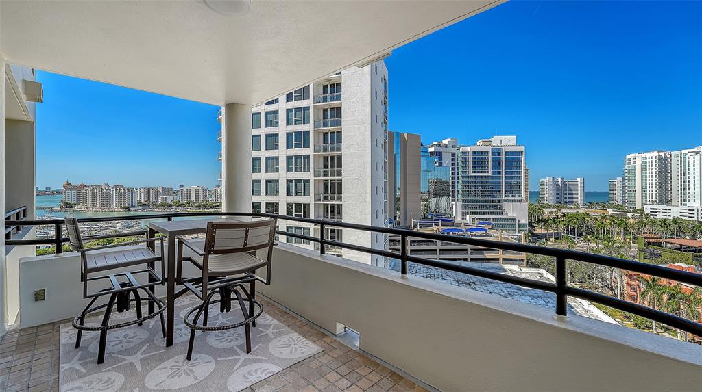 1255 North Gulfstream Avenue, Unit 1101 Sarasota, FL 34236 - Photo 13 of 75 a view of a balcony with chairs