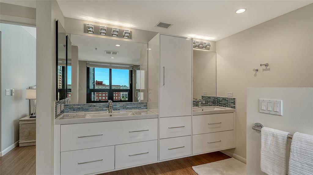 1255 North Gulfstream Avenue, Unit 1101 Sarasota, FL 34236 - Photo 40 of 75 a bathroom with a double vanity sink and mirror