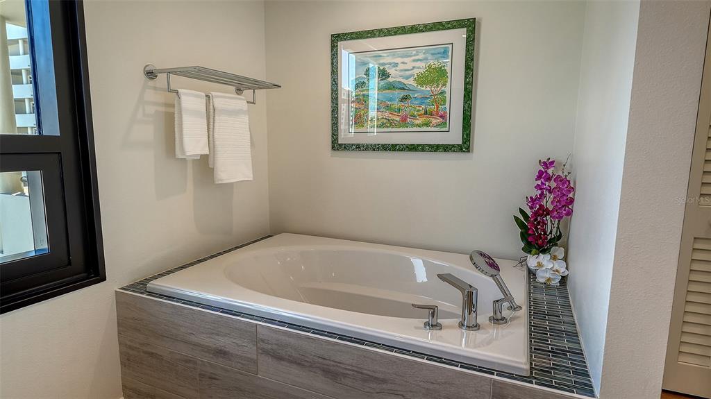 1255 North Gulfstream Avenue, Unit 1101 Sarasota, FL 34236 - Photo 43 of 75 a bath tub sitting next to a window
