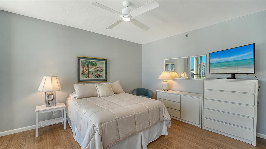 1255 North Gulfstream Avenue, Unit 1101 Sarasota, FL 34236 - Photo 44 of 75 a bedroom with a bed and a flat screen tv