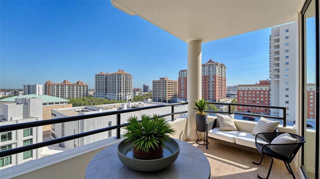 1255 North Gulfstream Avenue, Unit 1101 Sarasota, FL 34236 - Photo 47 of 75 a view of a balcony with furniture and a potted plant