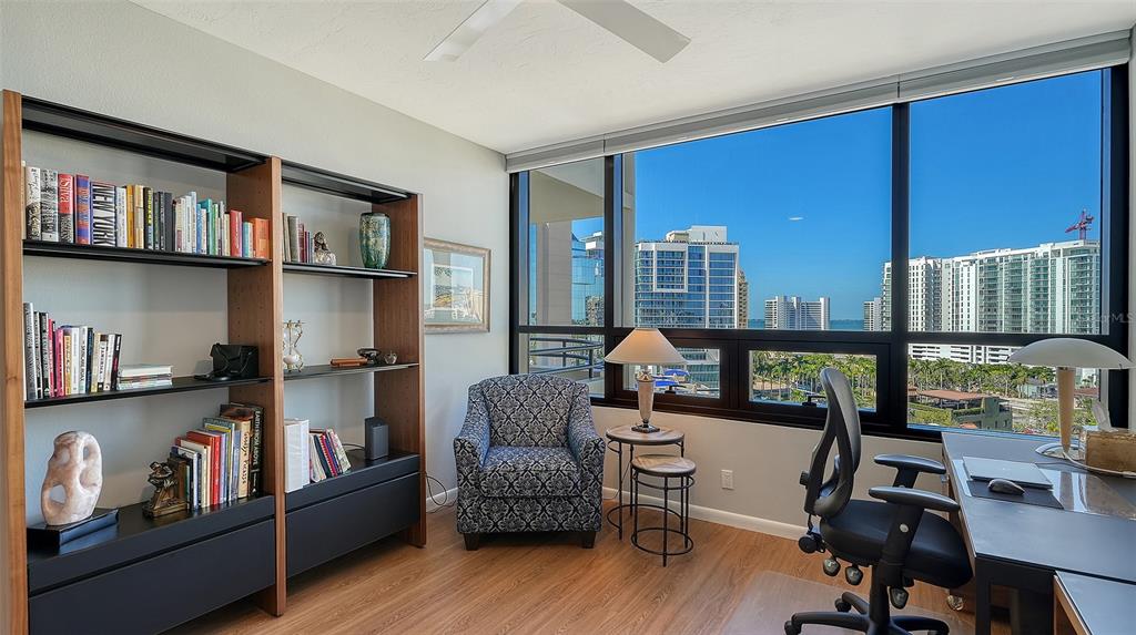 1255 North Gulfstream Avenue, Unit 1101 Sarasota, FL 34236 - Photo 54 of 75 a living room with furniture and a book shelf
