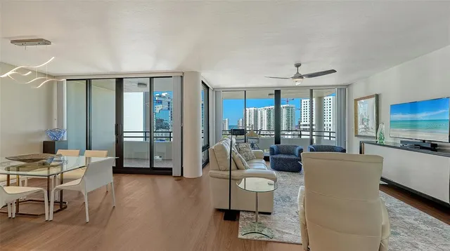 a view of living room kitchen with furniture and wooden floor
