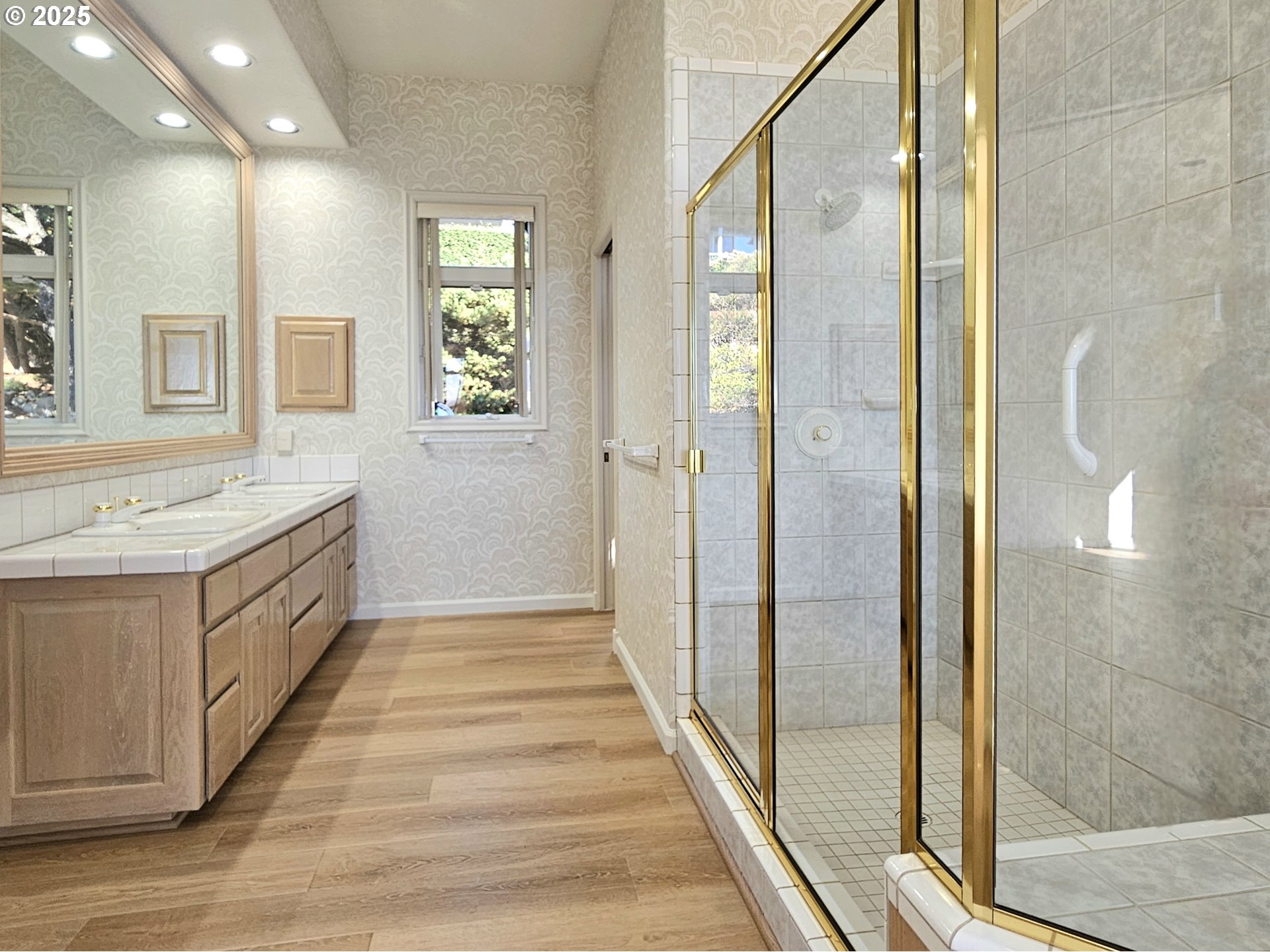96448 Shorewood Terrace Brookings, OR 97415 - Photo 24 of 48 a spacious bathroom with a double vanity sink a mirror and a shower