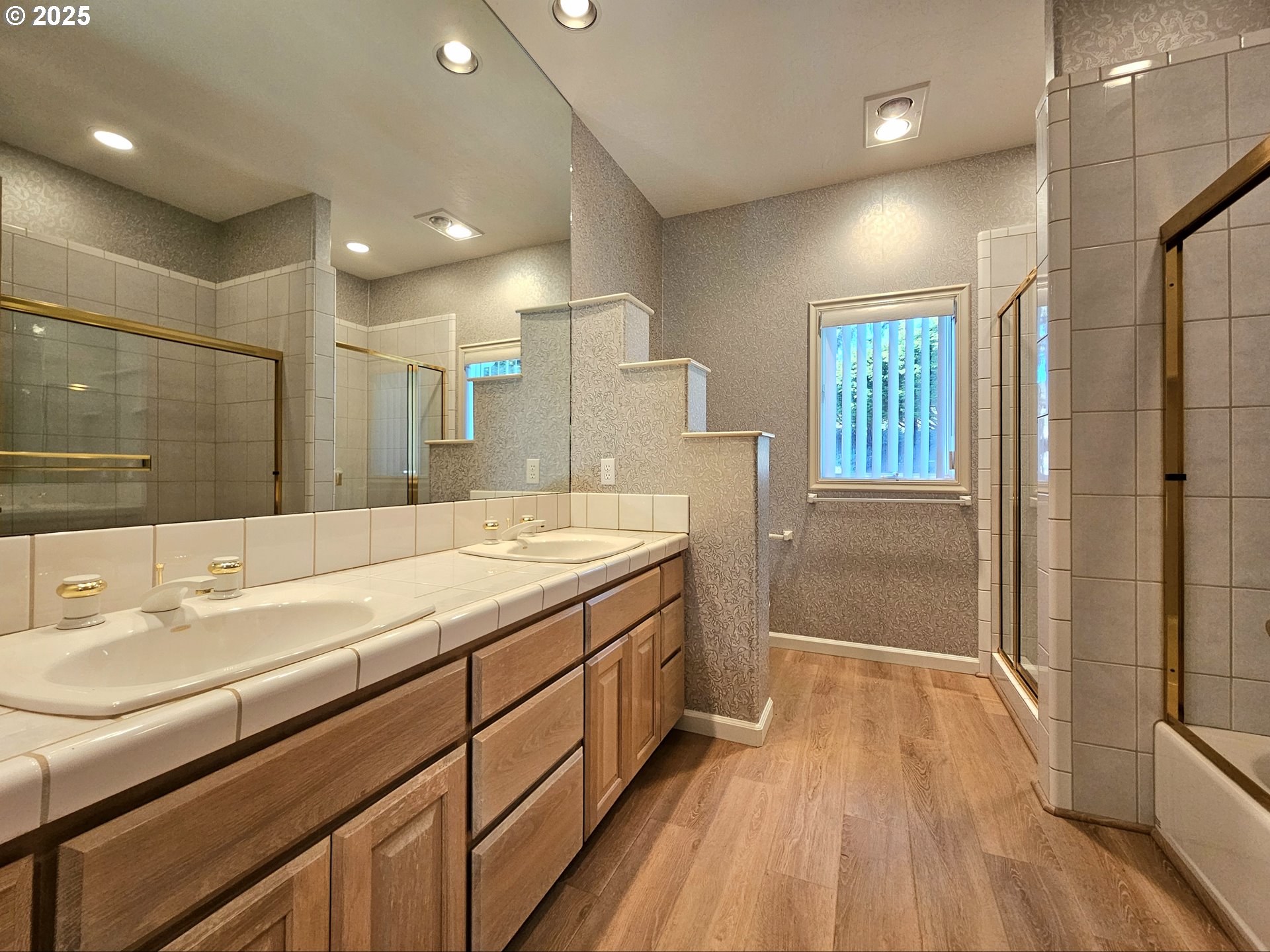 96448 Shorewood Terrace Brookings, OR 97415 - Photo 28 of 48 a spacious bathroom with a granite countertop sink a toilet a mirror and shower