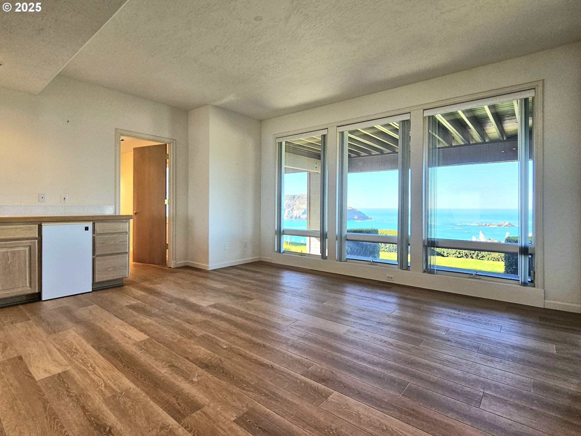 96448 Shorewood Terrace Brookings, OR 97415 - Photo 34 of 48 a view of an empty room with a window and wooden floor