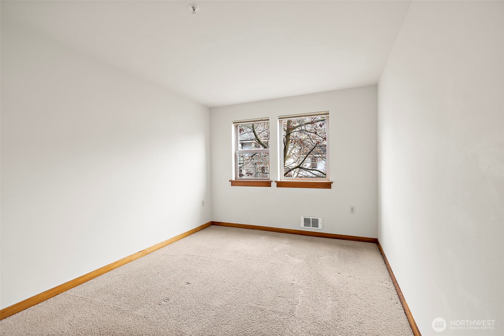 827 Hiawatha Place South, Unit 313 Seattle, WA 98144 - Photo 10 of 25 an empty room with windows