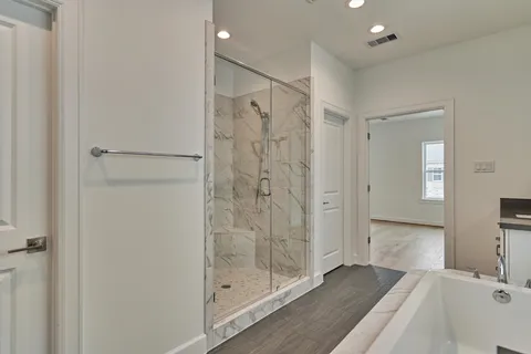 a bathroom with a shower and a sink