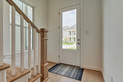 a view of an entryway with wooden floor